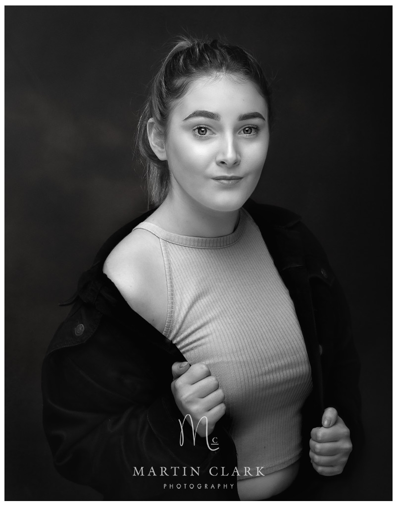 portrait of young woman with long hair wearing denim