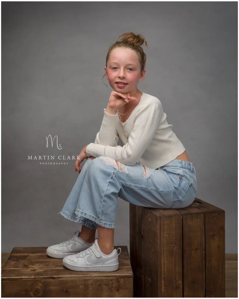 Young girl sitting on a box