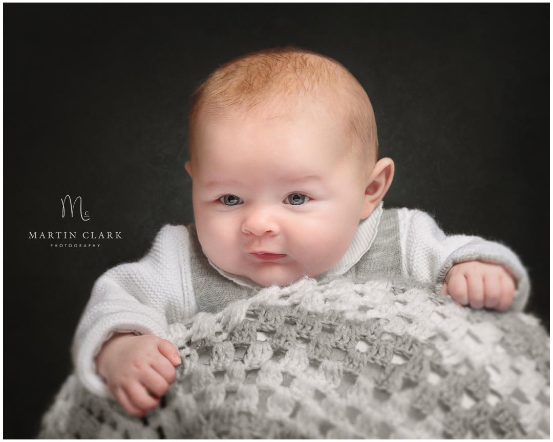 portrait of a baby on a blanket