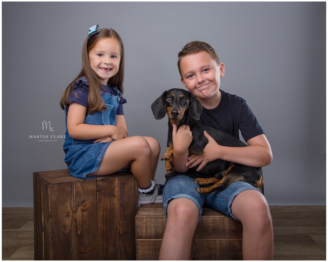 Brother and sister with their Dachshund dog