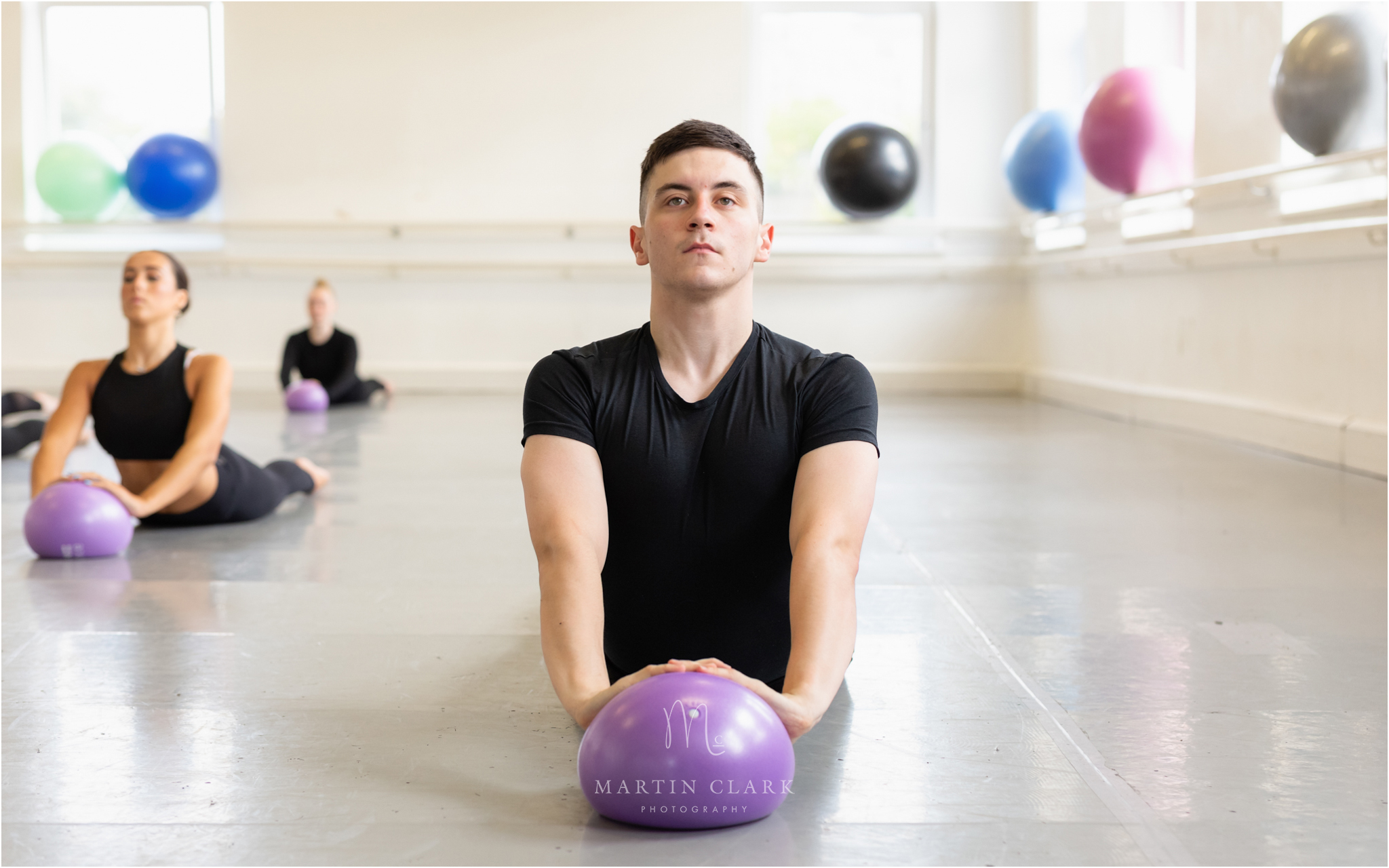 Hamilton Theatre Arts class for PBT with student practicing a ballet move on a mini inflatable ball