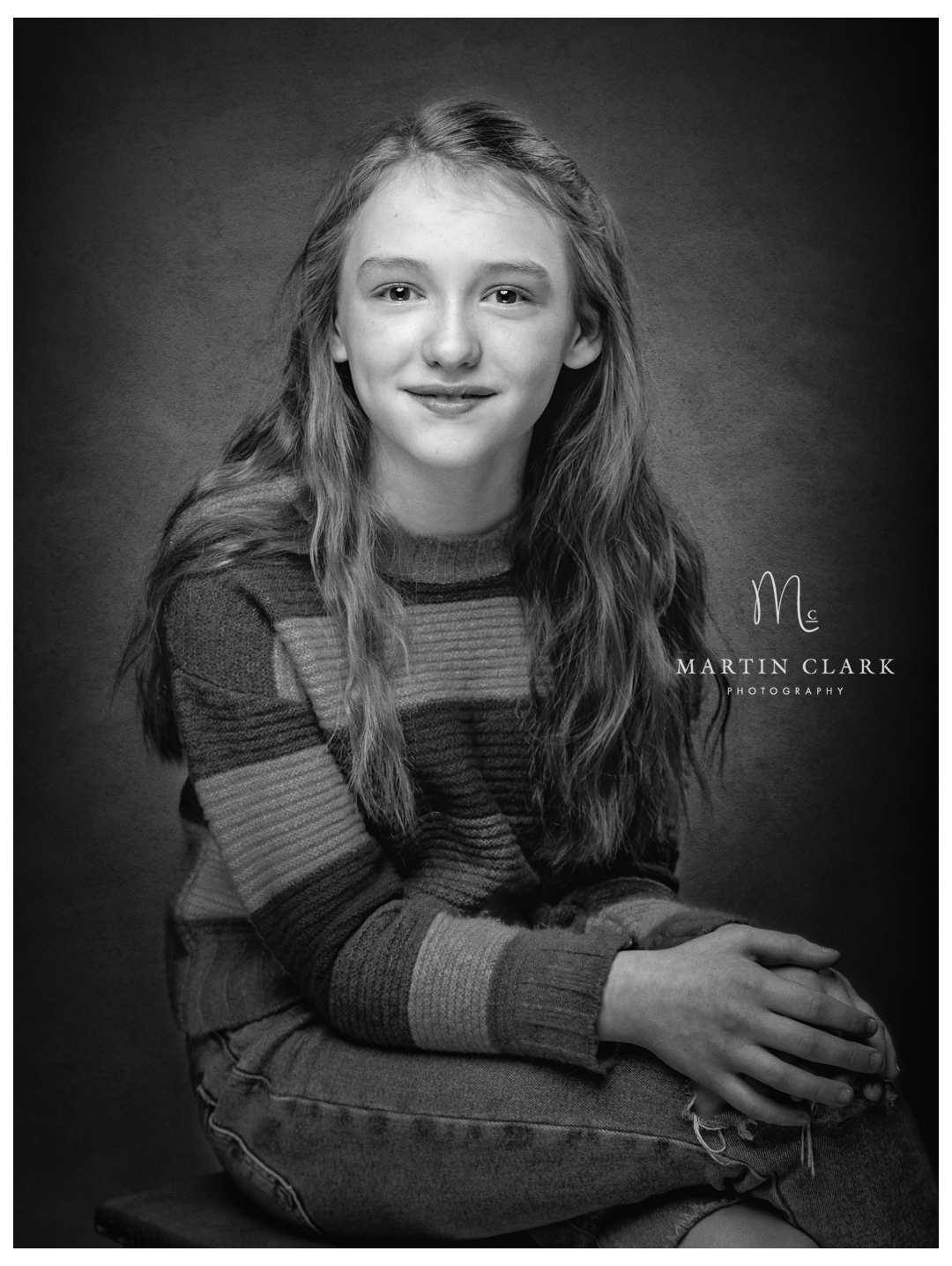 a teenage girl wearing a striped sweater