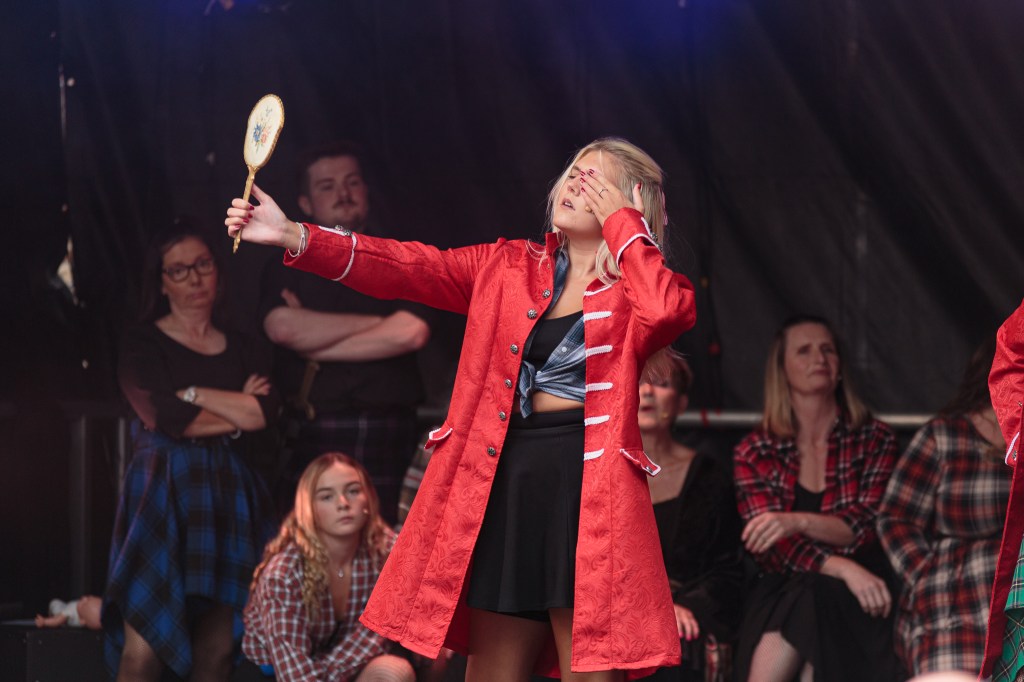 Actress playing a vain Bonnie Prince Charlie during an outdoor musical theatre performance