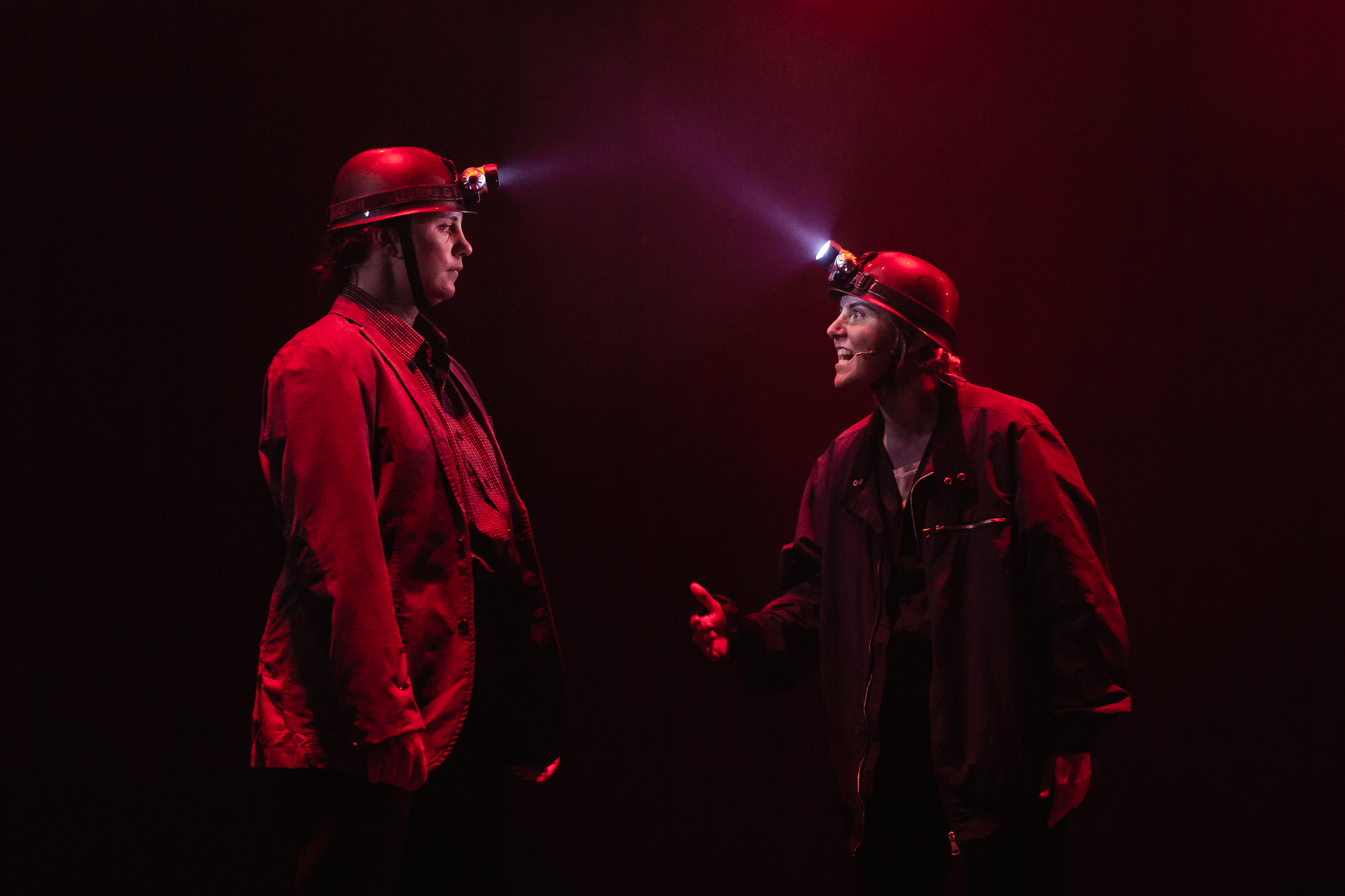 Theatre Alliance actors performing their production Knockshinnoch at Cumnock Town Hall with image showing dramatic lighting of miners