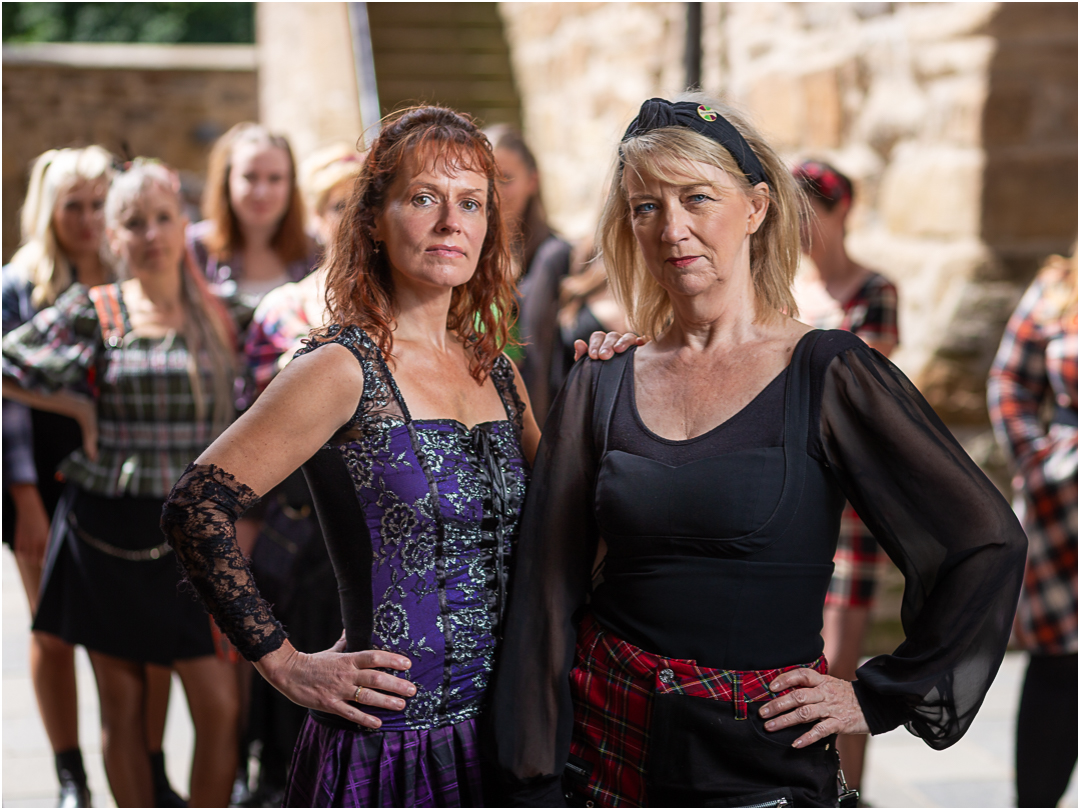 Two Jacobite Rebel women dressed in tartan in a Scottish castle