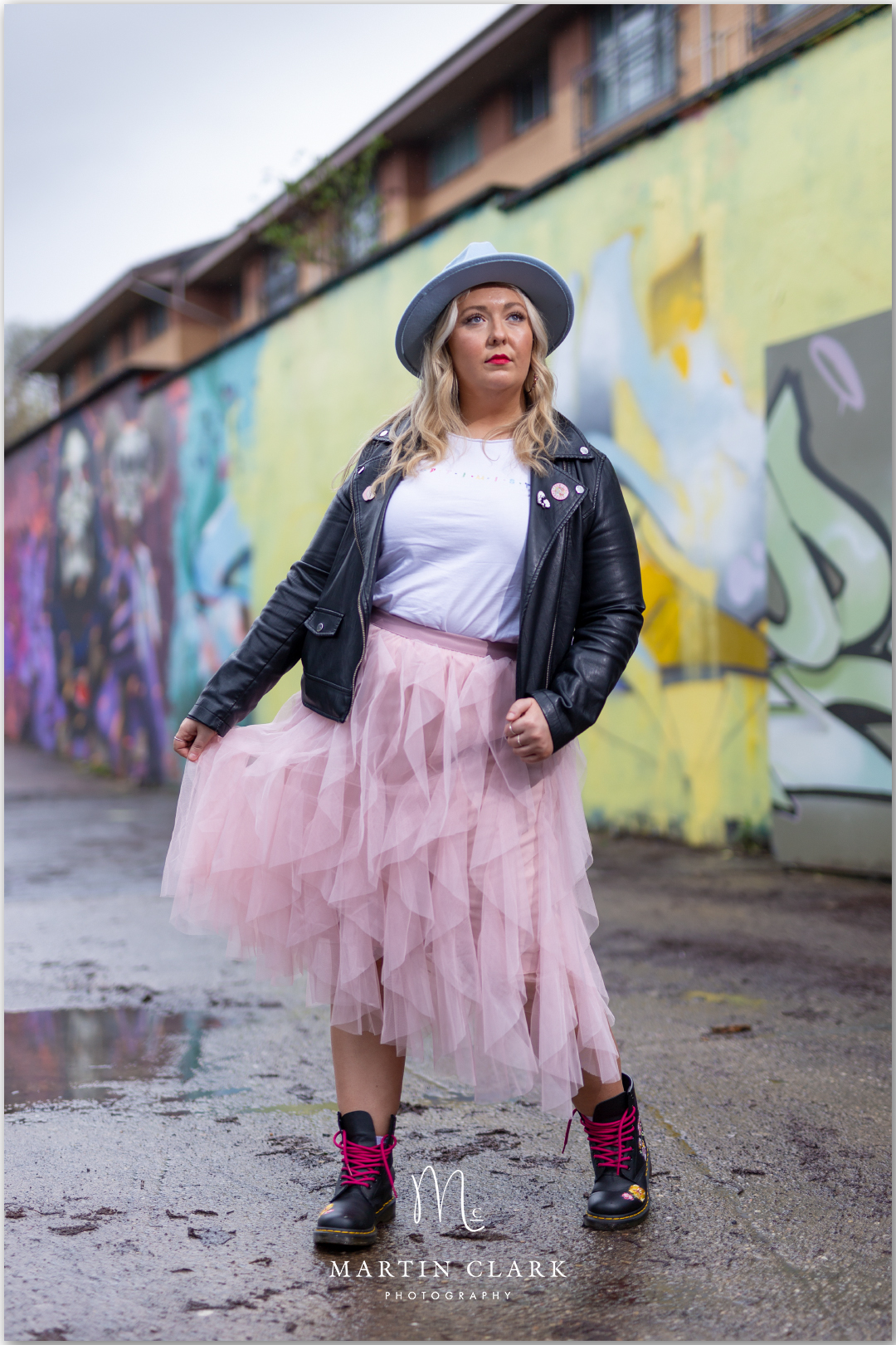 Model dressed in leather jacket with pink tutu in an urban setting