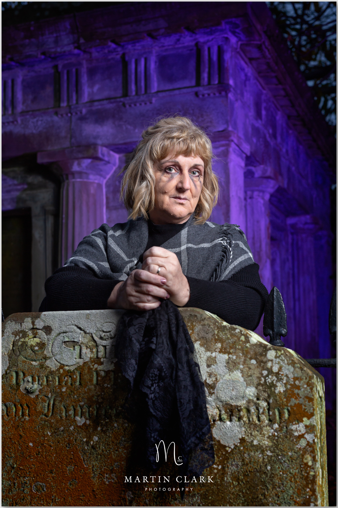woman in witches costume in a graveyard