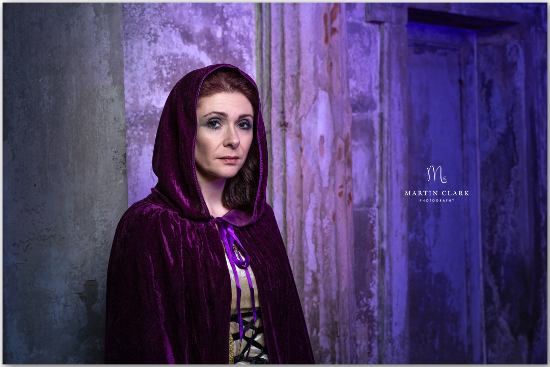 Woman in purple hooded cloak