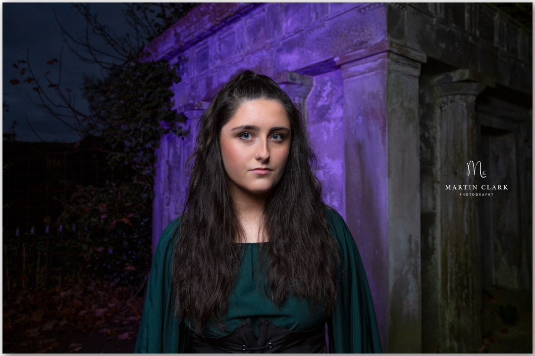 Young woman portrait beside a graveyard crypt