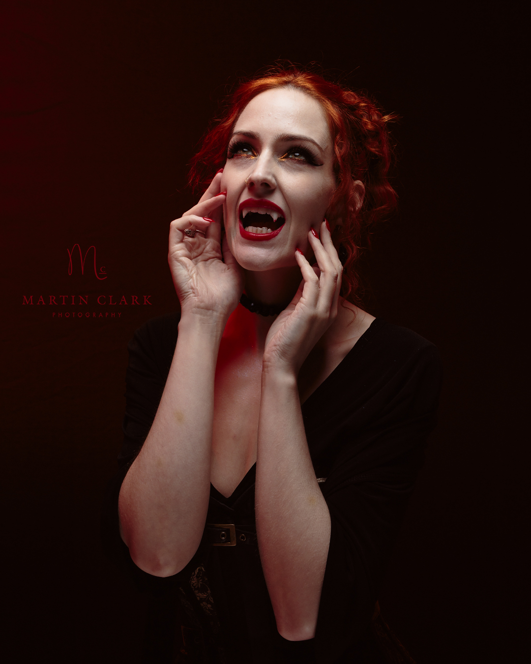 a model dressed as a vampire with red tones