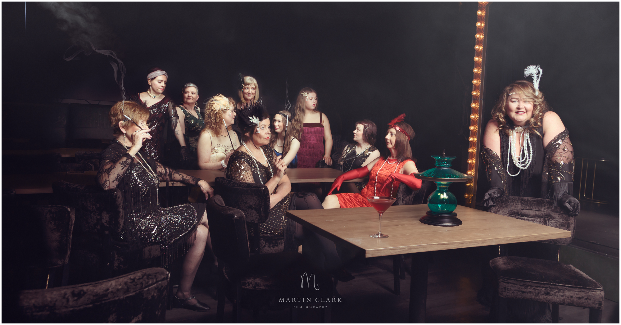 Women dressed in 1920s period costume representing a Speakeasy bar during prohibition