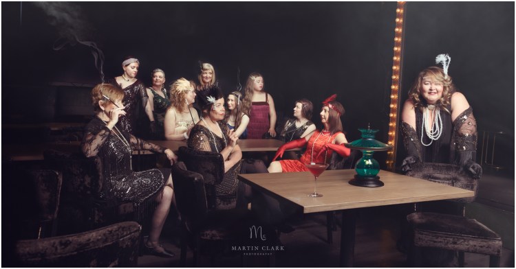 Women dressed in 1920s period costume representing a Speakeasy bar during prohibition